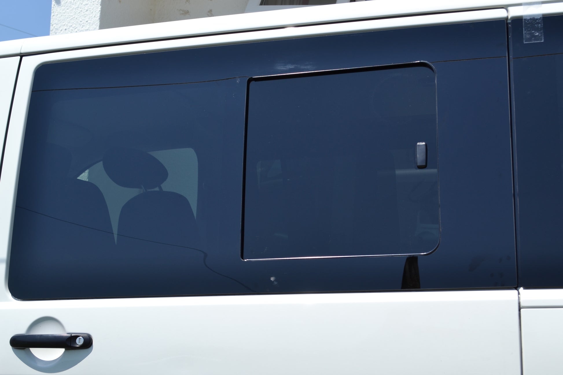 white vw t5 van with a tinted sliing window